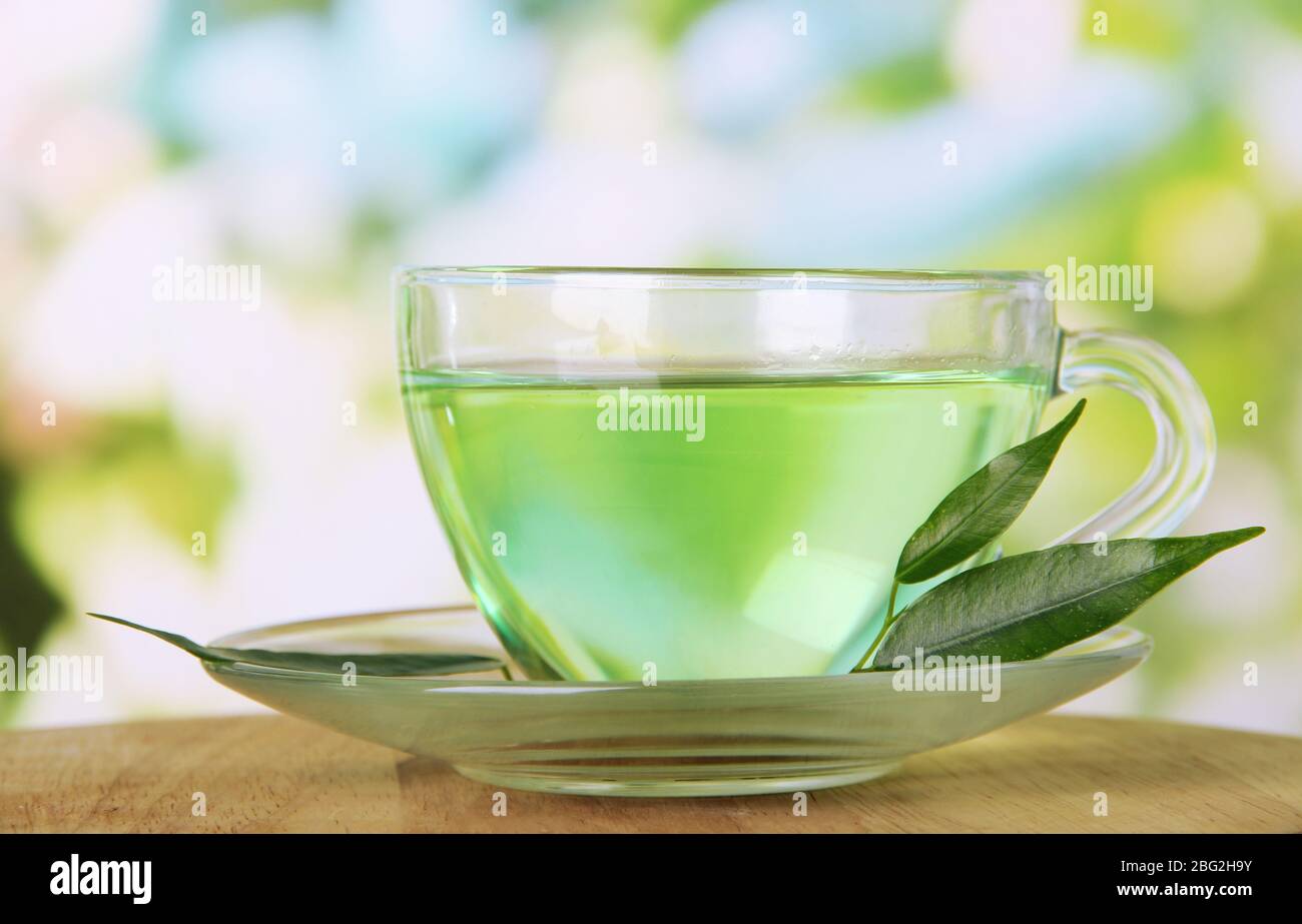 Transparent cup of green tea, on nature background Stock Photo - Alamy