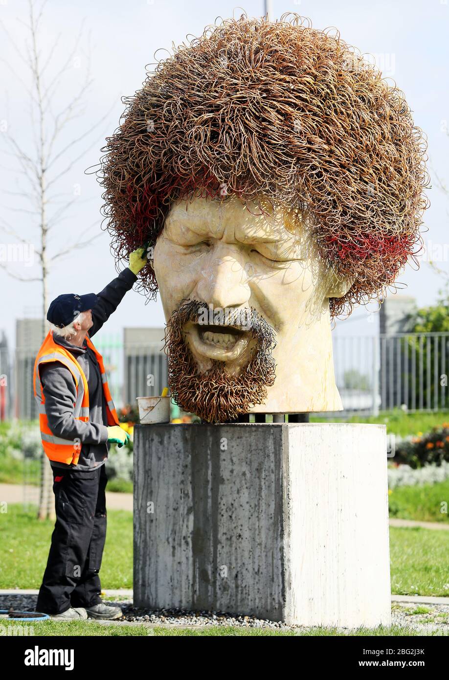 Ross Sheridan of P.Mac Cleaning and Restoration services working on behalf of Dublin City Council cleans a statue of the late musician Luke Kelly in the Sherriff street area of Dublin, after it was defaced for the fourth time in the past year. Stock Photo