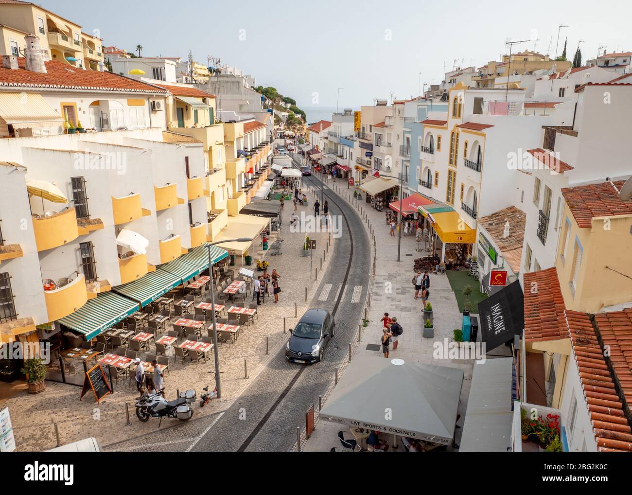 Main Street, Carvoeiro, Portugal. A raised view of bars and restaurants of the central Rua Do