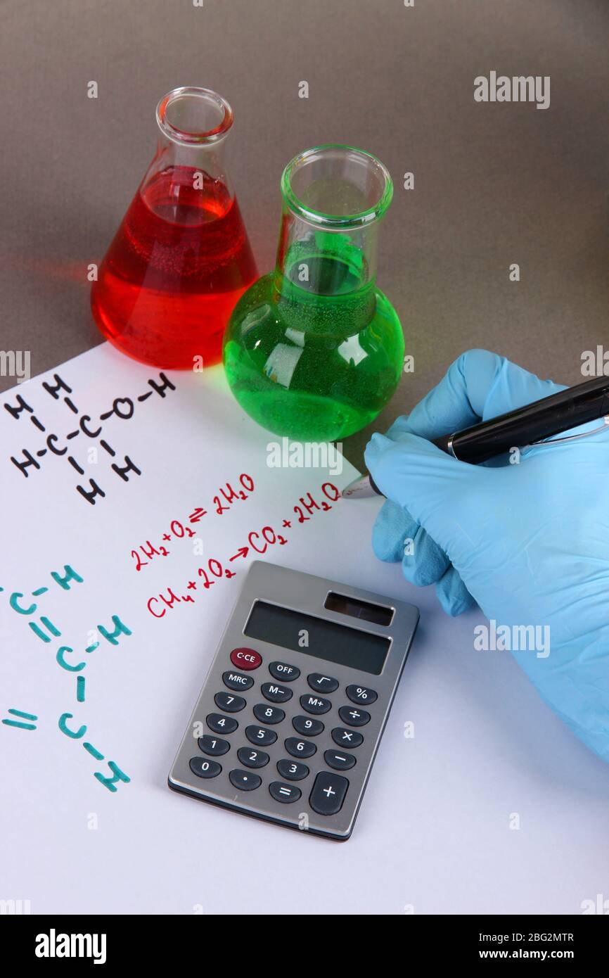 Hand scientist writing formulas Stock Photo - Alamy