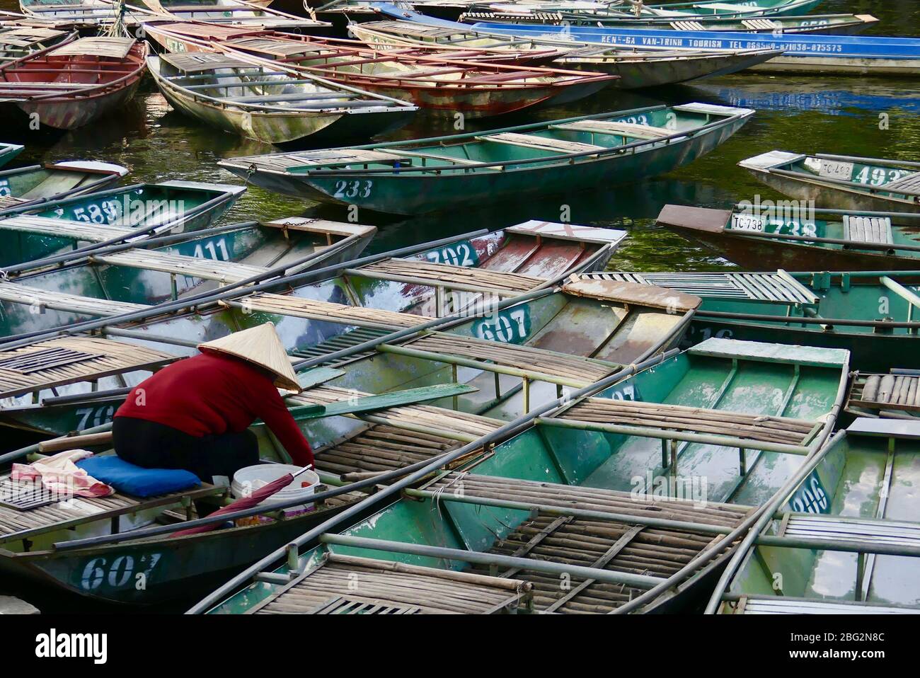 Sightseeing boats docked on the Tam Coc River in Ninh Binh, Vietnam Stock Photo