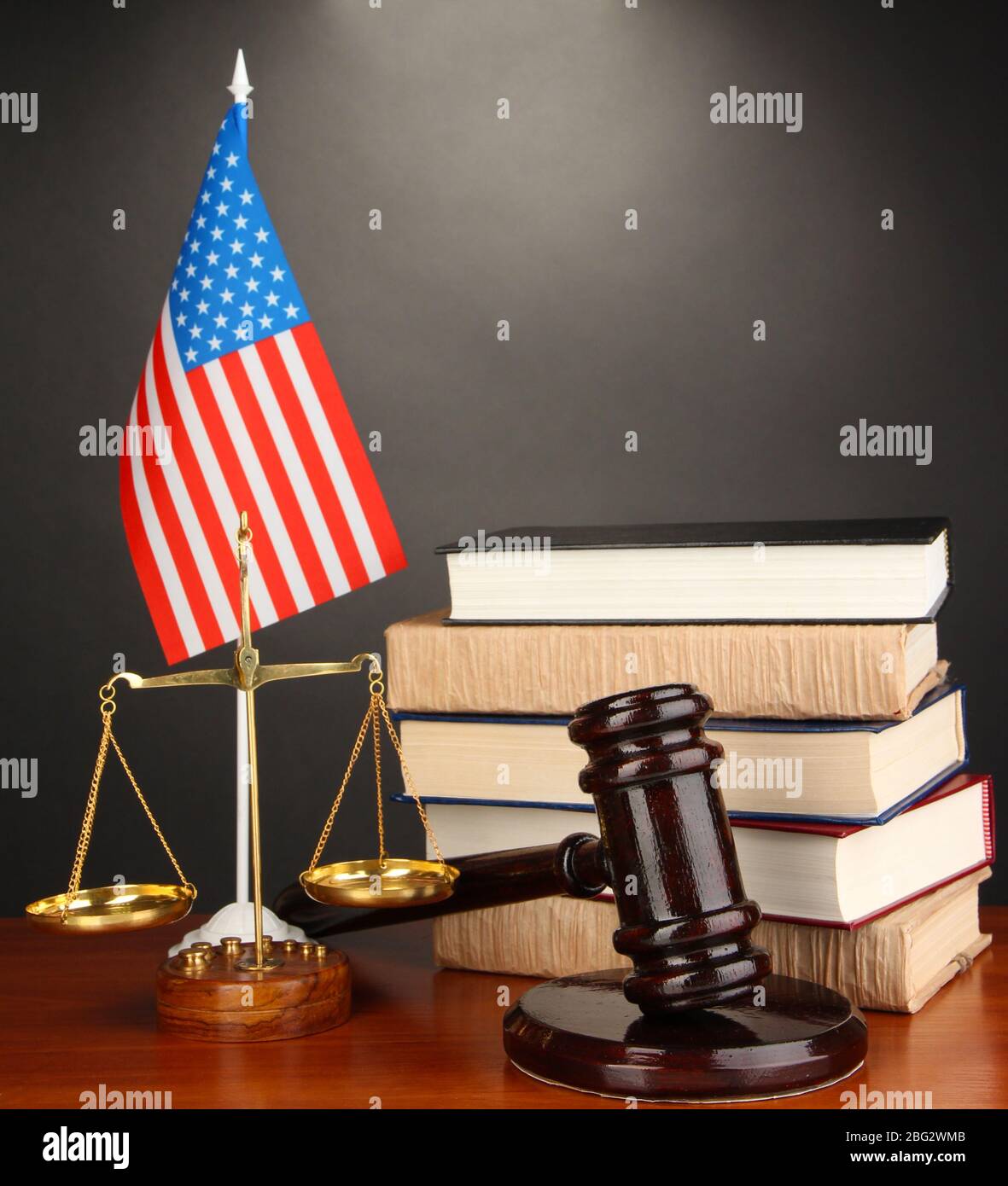 Wooden gavel, golden scales of justice and books on grey background ...