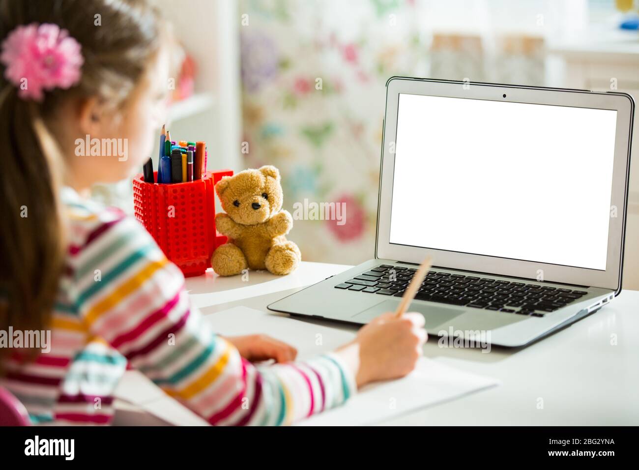 Primary school student having video conference call with teacher using webcam. Online education and e-learning concept. Home quarantine distance learn Stock Photo