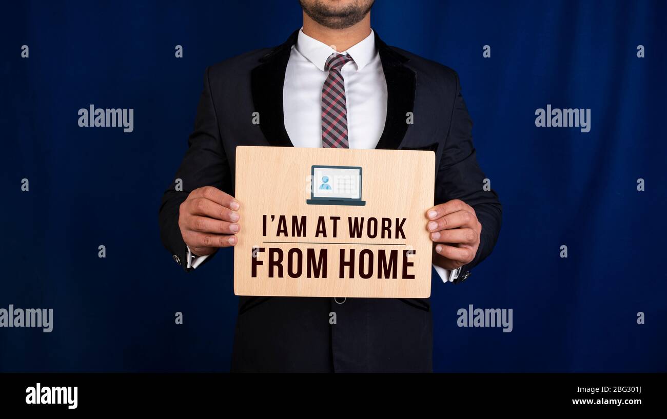 Professional holding work from home sign in hands Stock Photo