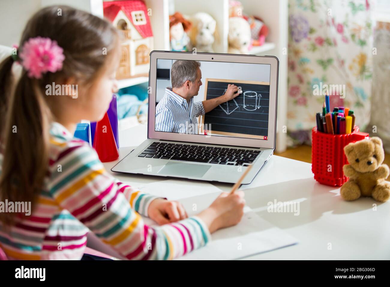 Middle-aged distance teacher having video conference call with pupil using webcam. Online education and e-learning concept. Home quarantine distance Stock Photo