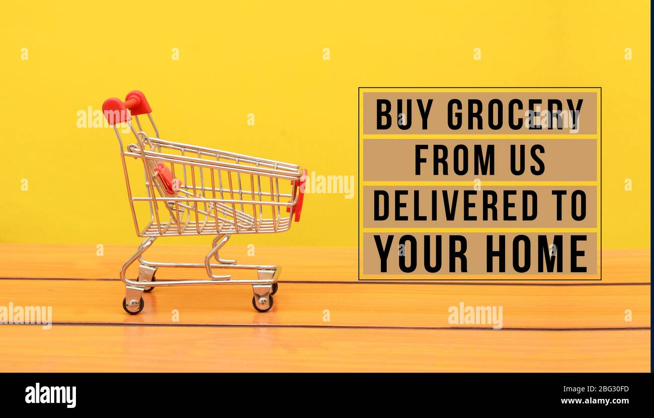 Buy Your Grocery from Us during COVID-19 Banner with shopping cart Stock Photo