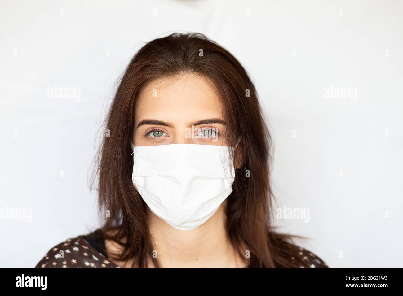 portrait of beautiful young woman wearing cotton white mask and medical ...