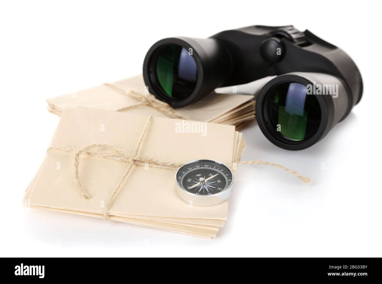Black modern binoculars with old letters isolated on white Stock Photo