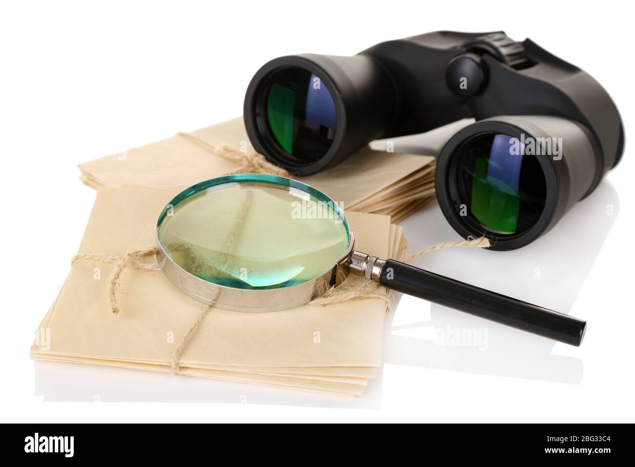 Black modern binoculars with old letters isolated on white Stock Photo
