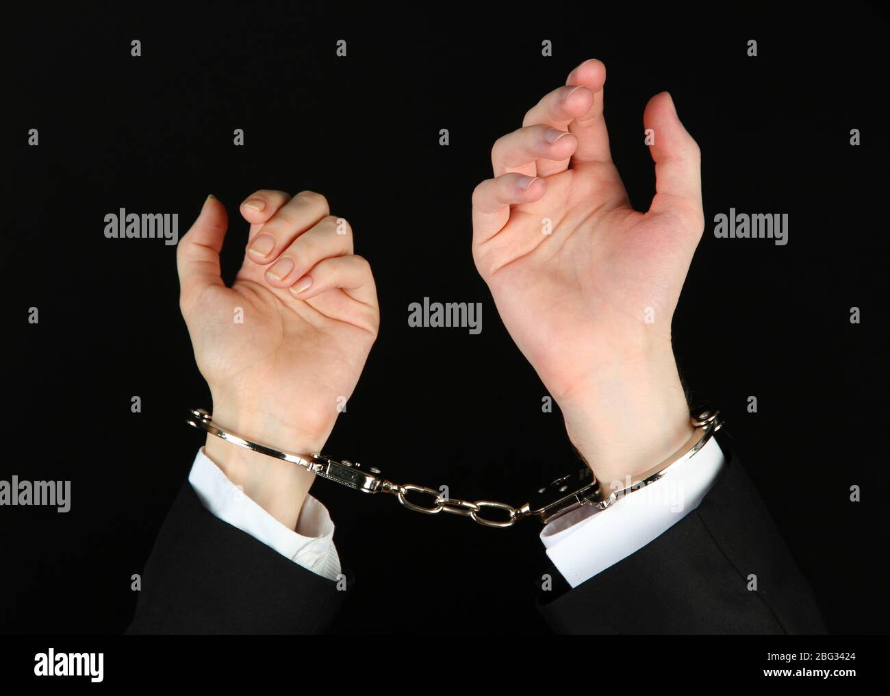 Man and woman hands and breaking handcuffs isolated on black background