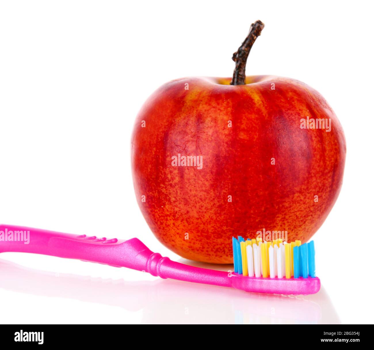 Apple with a toothbrush isolated on white Stock Photo Alamy
