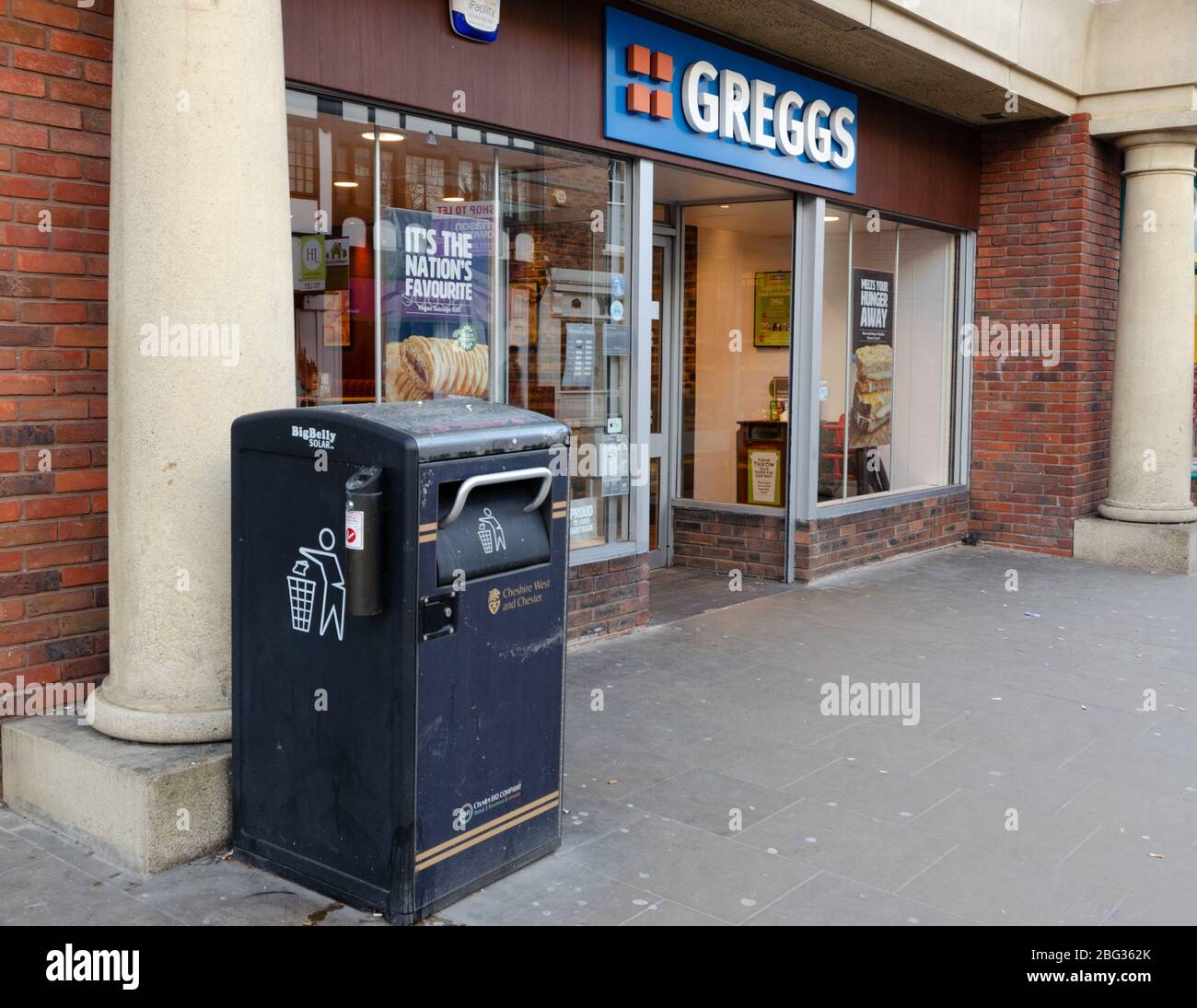 Chester, UK: Mar 1, 2020: A large solar powered waste bin located next to the Frodsham Street branch of Greggs. Stock Photo