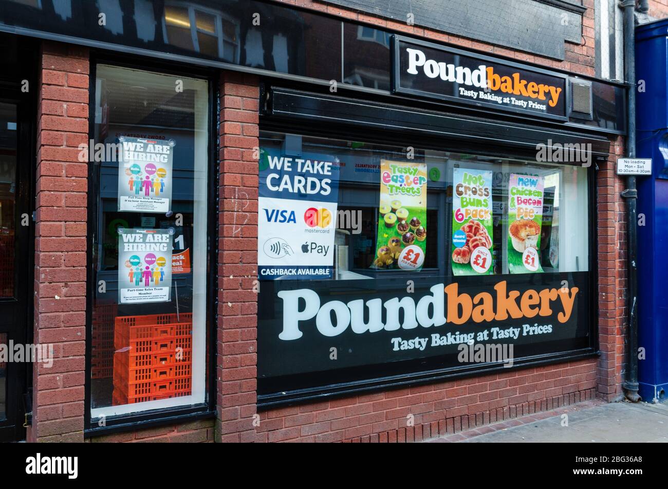 Chester, UK: Mar 1, 2020: A Poundbakery store displays posters advertising available jobs. Additional posters promote some Easter offers. Stock Photo