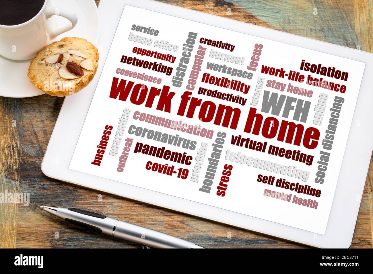 work from home word cloud on a digital tablet with a cup of coffee, social distancing, self quarantine and stay-at-home order during covid-19 coronavi Stock Photo