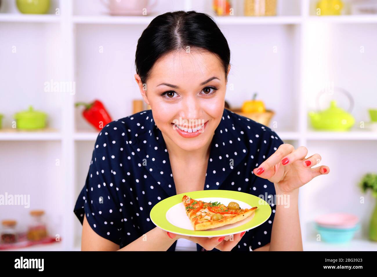 Girl with delicious pizza on kitchen background Stock Photo Alamy