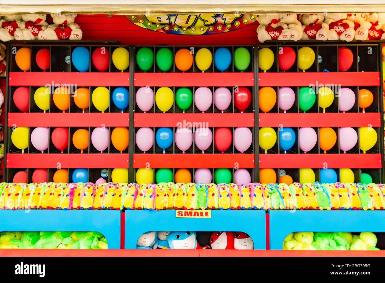 balloons and prizes at a dart throwing game booth at a carnival, fair