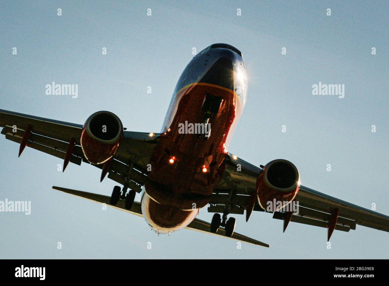 Airplane in the process of landing on runway Stock Photo