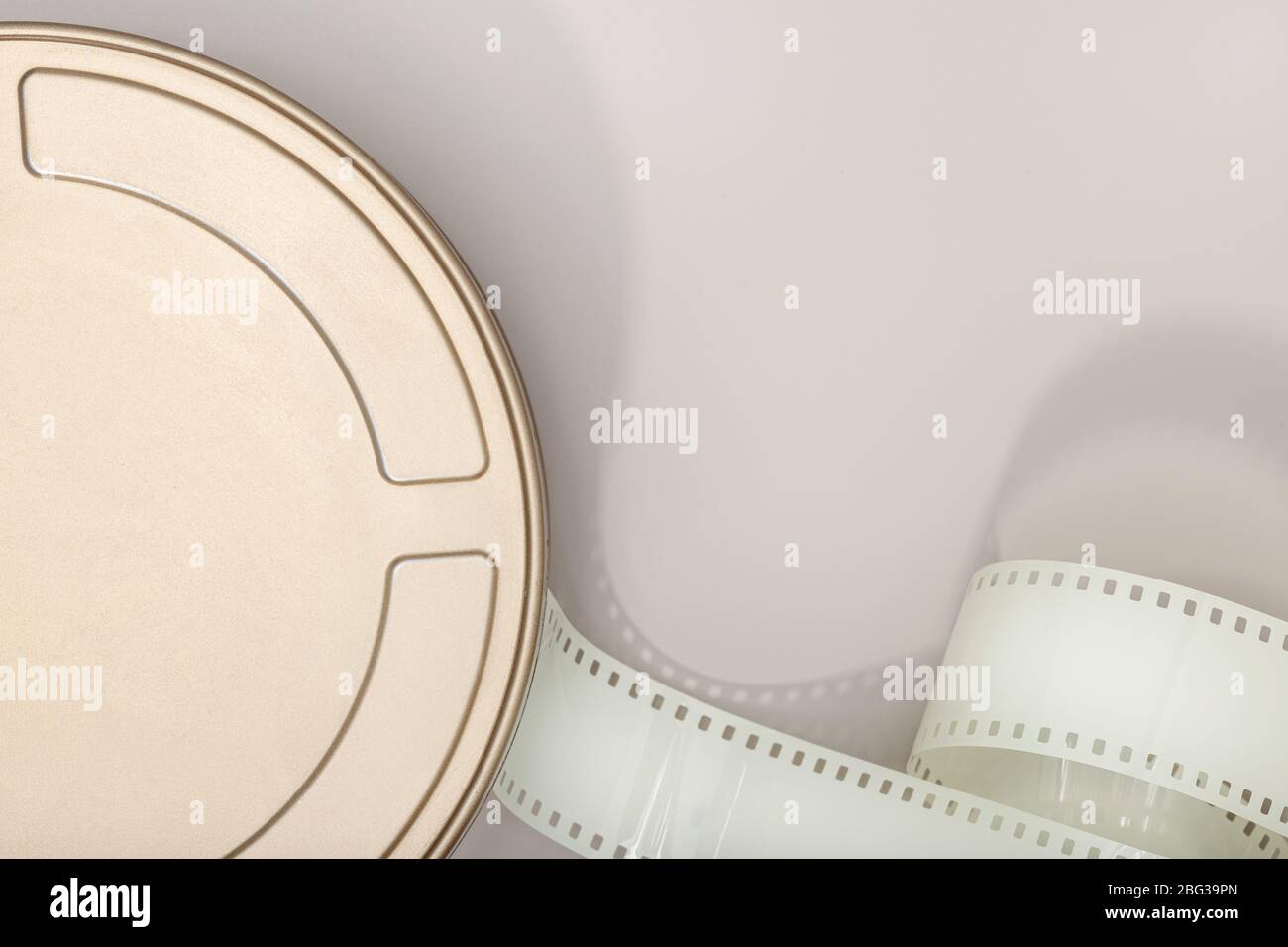 Motion Picture Film Can and film strip on table. Movie or TV background. Top view, Copy space Stock Photo