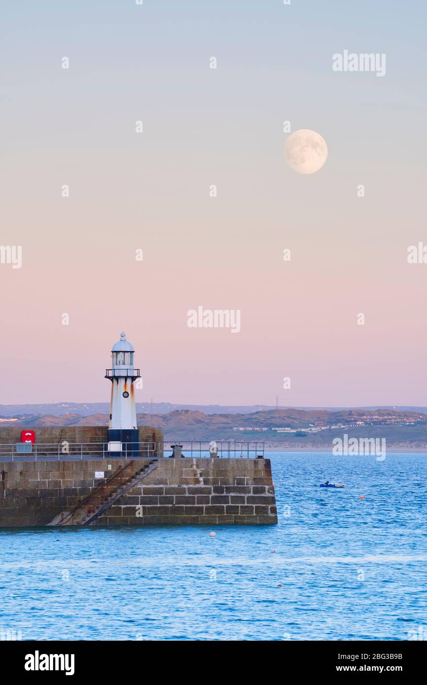 Supermoon rising above St Ives Harbour at Sunset, Cornwall Stock Photo