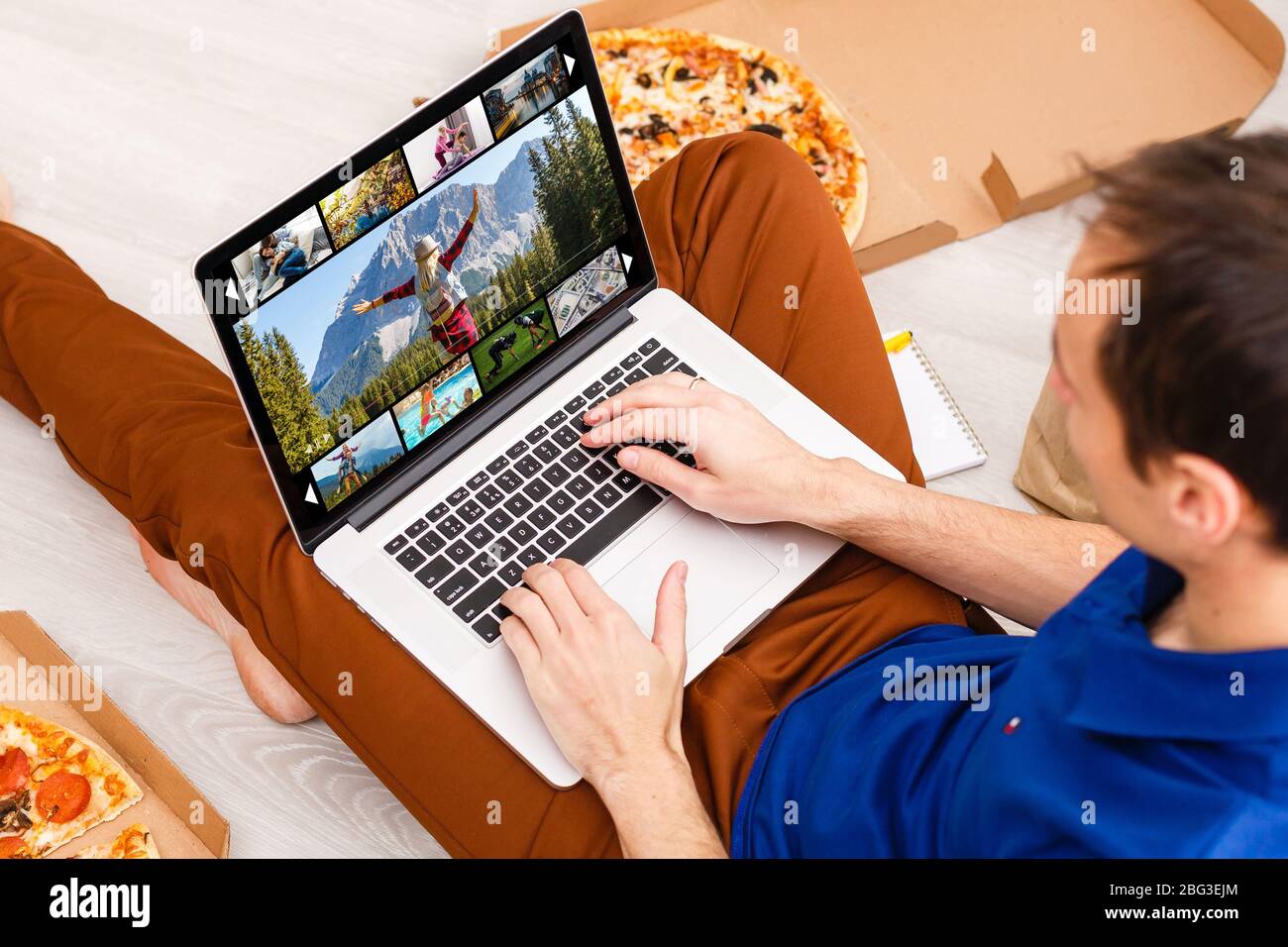 Man watching TV channels by laptop online Stock Photo - Alamy