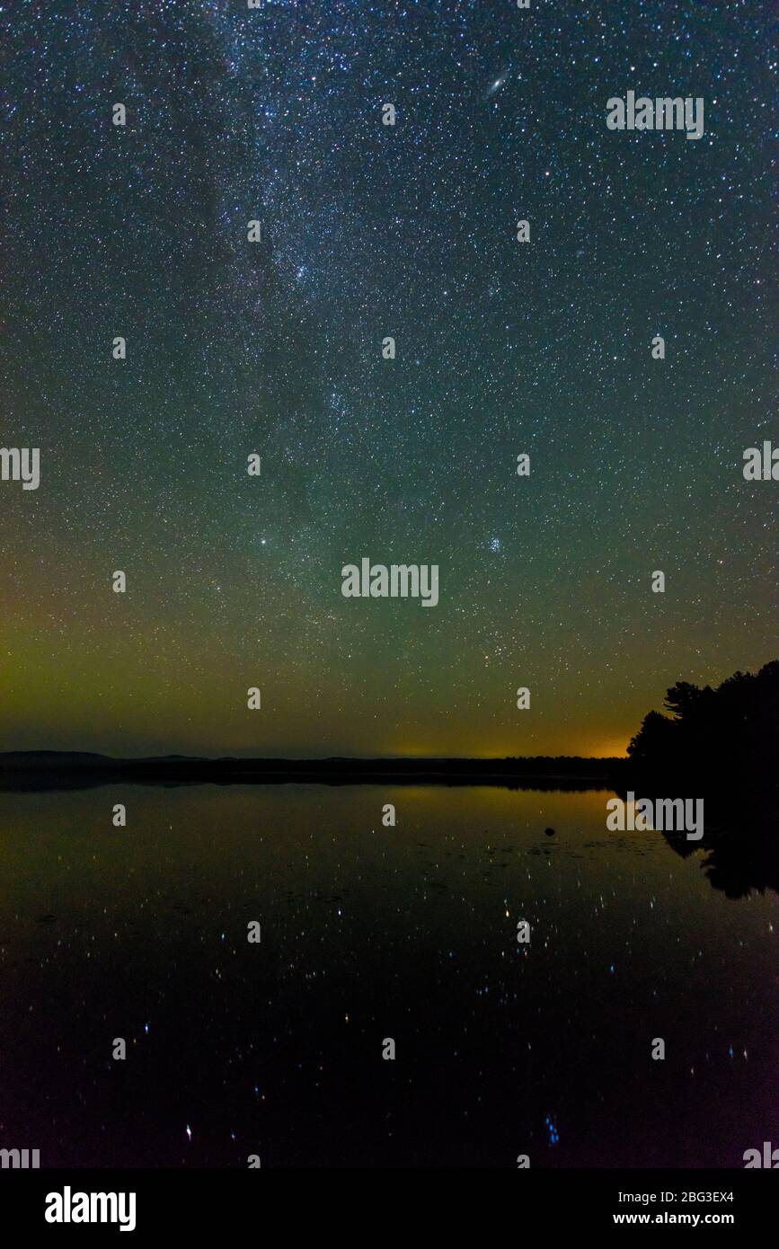 Night sky with Milky Way and faint aurora borealis over Lake Travers, Algonquin Provincial Park, Nipissing Township, Ontario, Canada Stock Photo