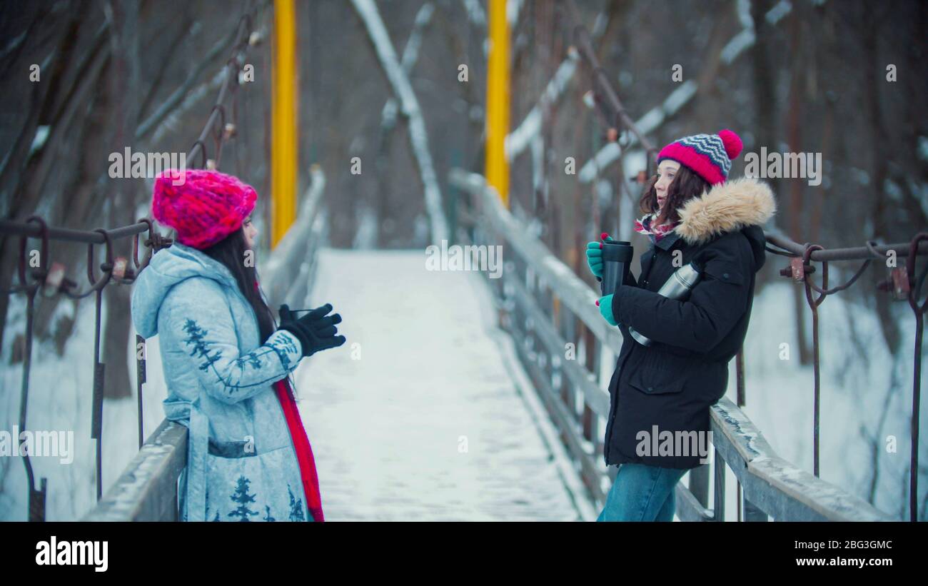 Two women on snowy bridge hi-res stock photography and images - Alamy