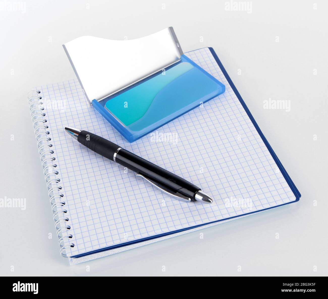 Blue business card holder, notebook and pen isolated on white Stock Photo