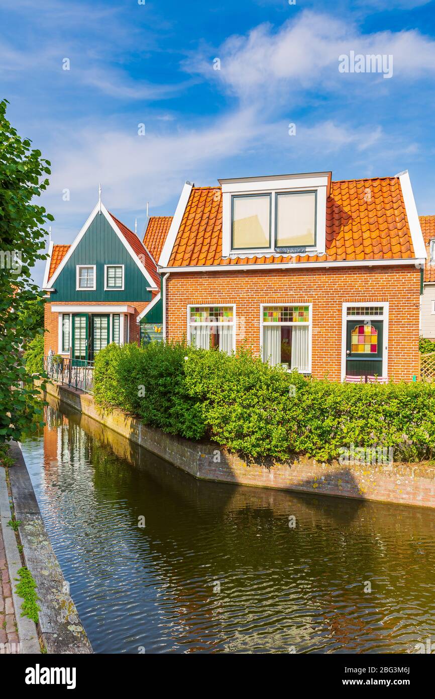 Old streets in Volendam. Old traditional fishing village, typical wooden houses architecture. Popular landmark and travel destination for tourists. Stock Photo