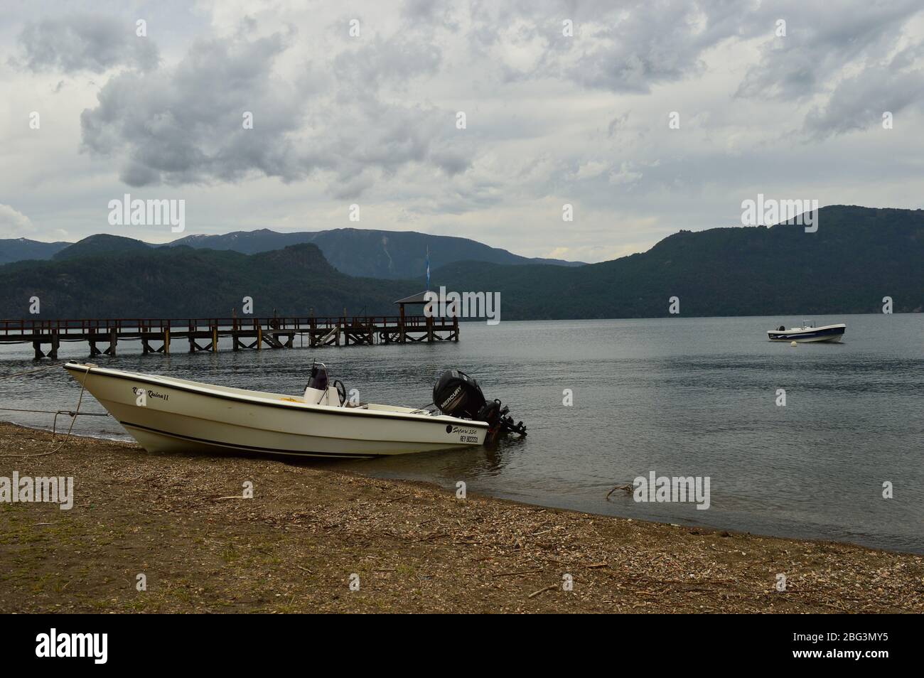 Boats and a Jetty on a Patagonian Lake Stock Photo