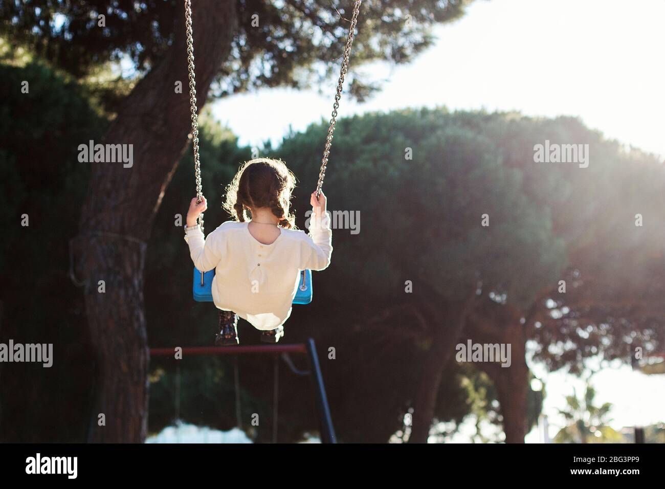 Rear view of a girl on a swing, Spain Stock Photo Alamy