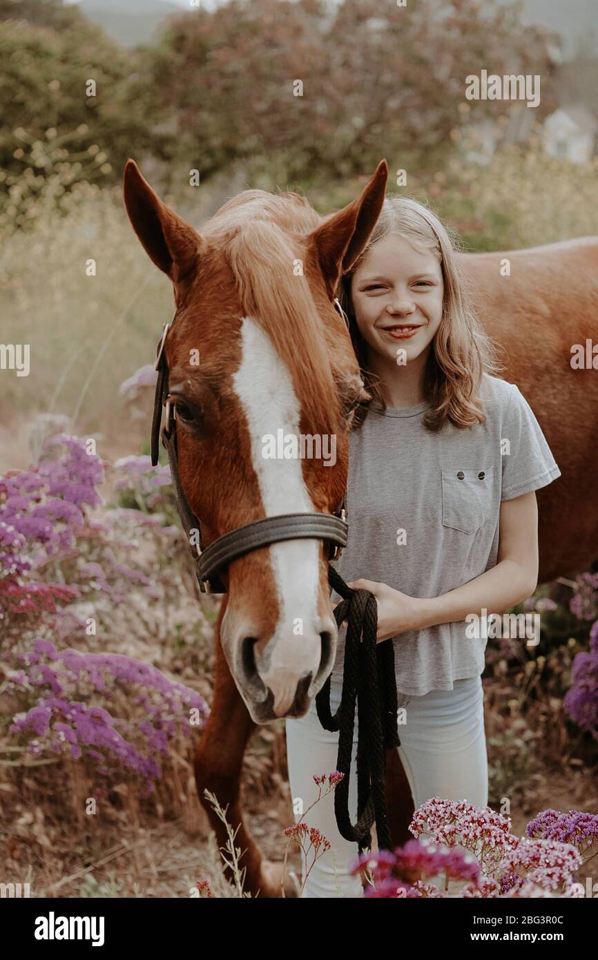 Portrait of a girl standing with her horse, California, USA Stock Photo