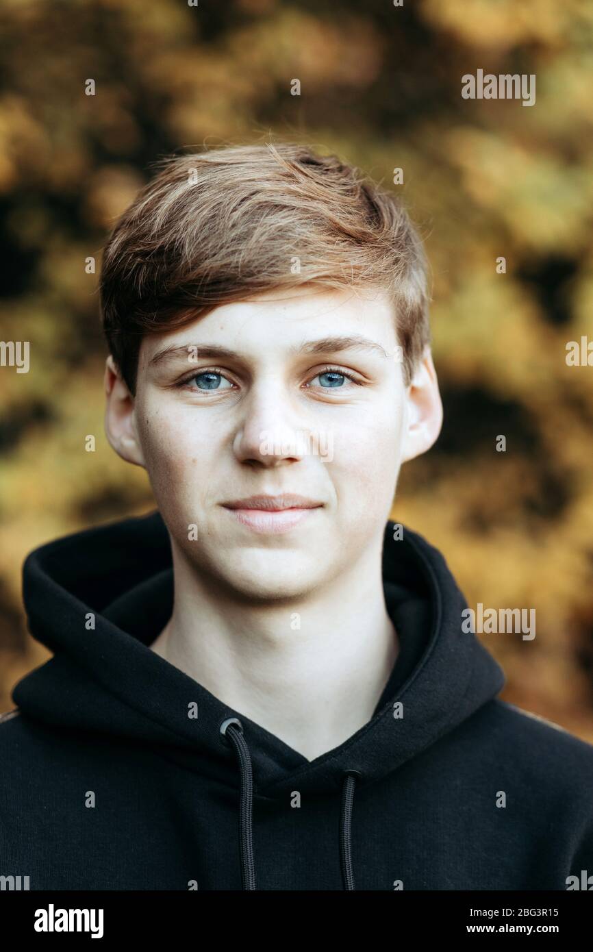 Portrait of a smiling teenage boy standing outdoors in autumn, Netherlands Stock Photo