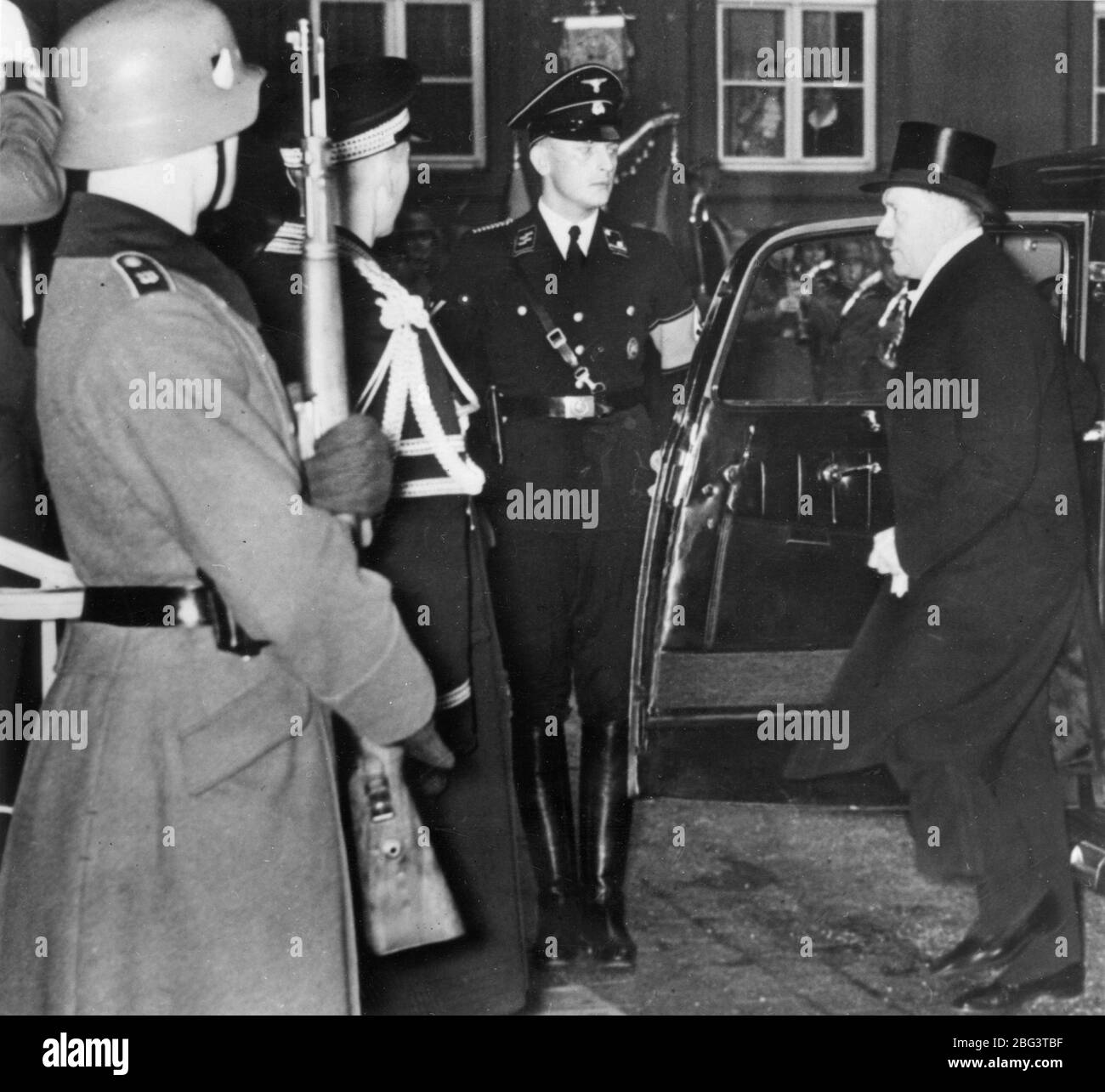 Adolph Hitler in top hat, arriving at the Chancellery to give a speech to the German diplomatic corps, about peace with the Vatican. 1932 - 1933.  Pre WW II.  To see my related images, Search:  Prestor  vintage   WW II  weapon Stock Photo