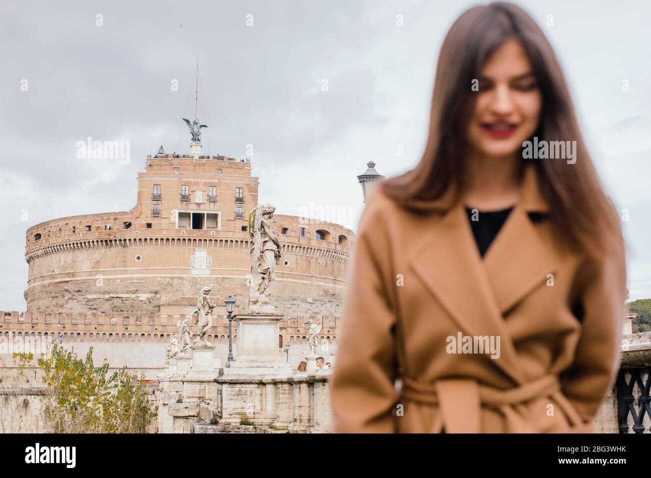 Woman standing in front of Castel Sant'Angelo, Mausoleum of Hadrian, Rome, Lazio, Italy Stock Photo