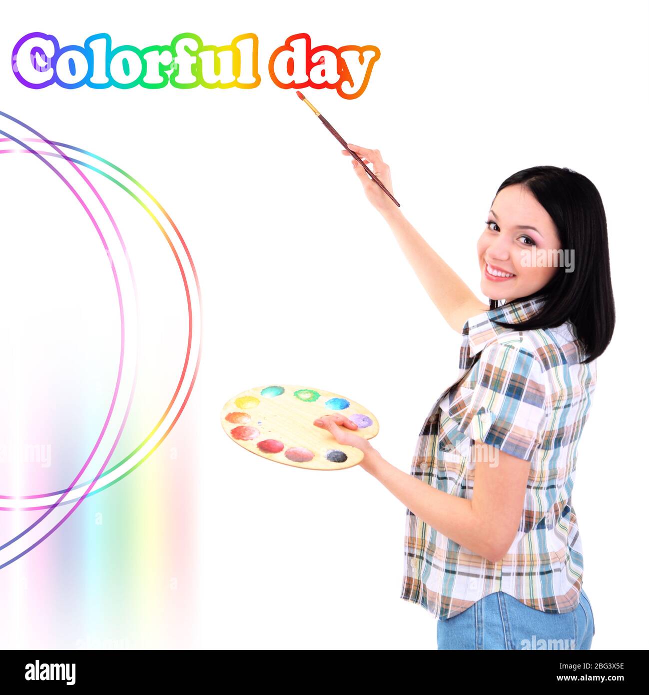 Beautiful young woman painter with brushes and palette at work ...