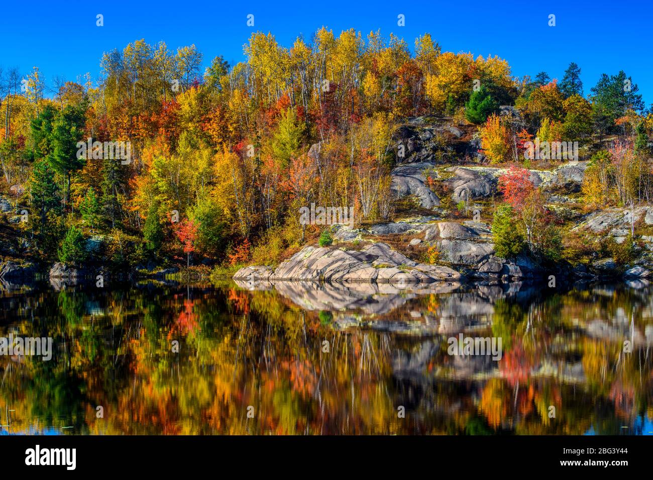 Autumn reflections in Elbow Lake, Greater Sudbury, Ontario, Canada