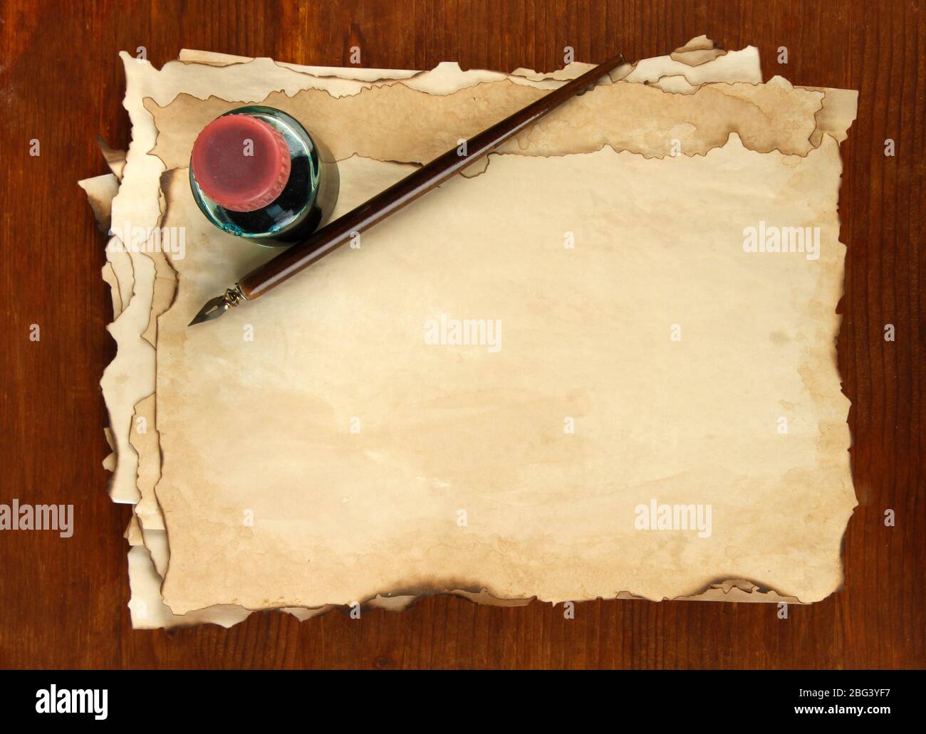 Old paper, ink and ink pen on wooden background Stock Photo - Alamy
