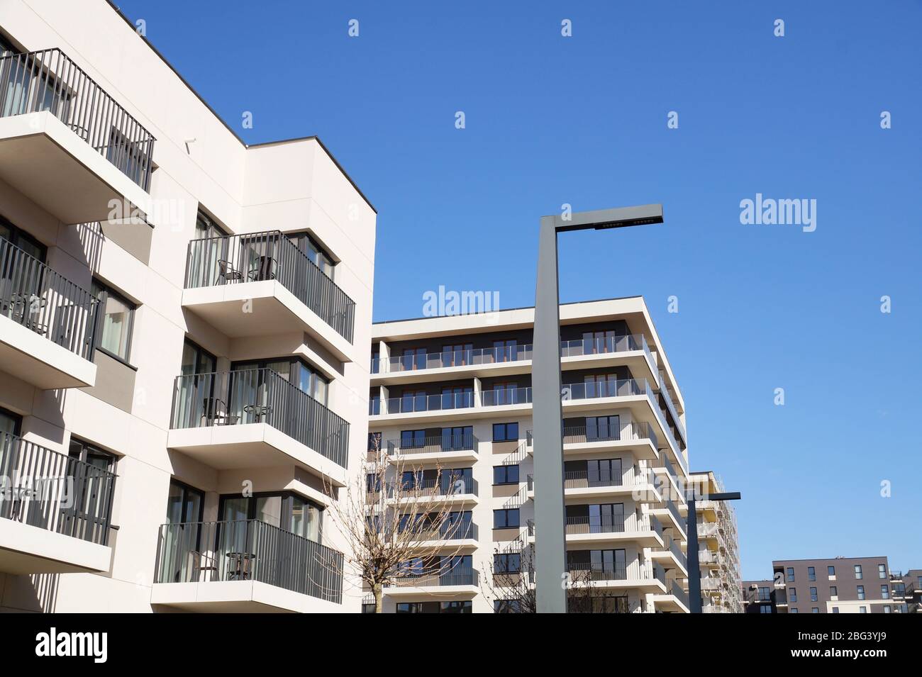 Construction of houses, final stage of construction. A newly built housing estate of multi-family houses. Stock Photo