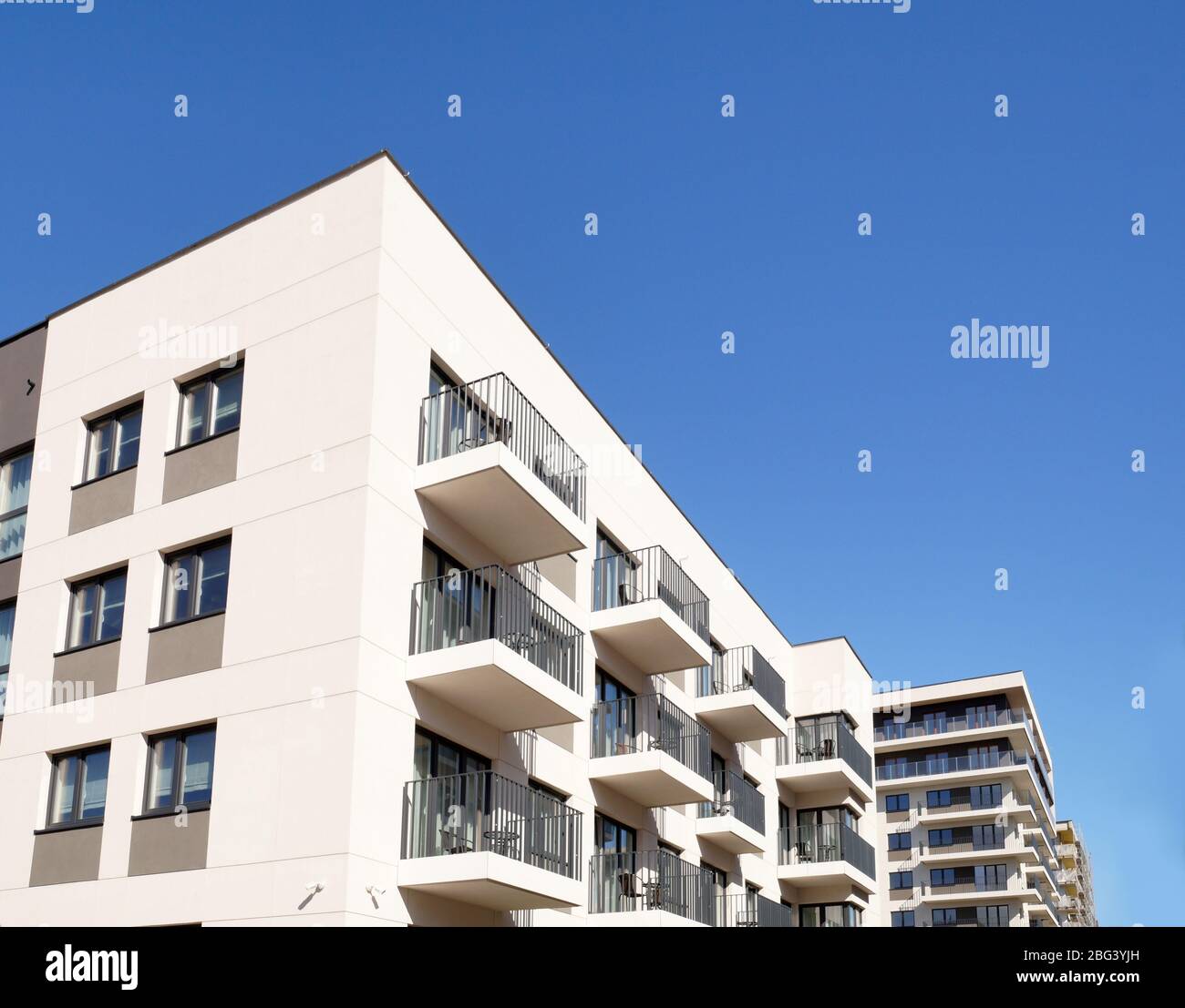 Construction of houses, final stage of construction. A newly built housing estate of multi-family houses. Stock Photo