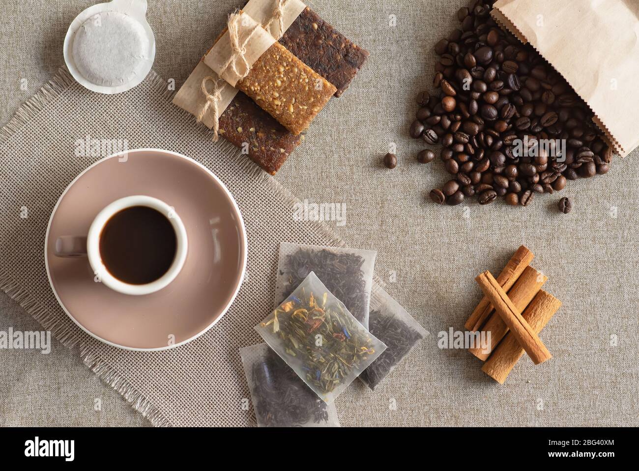 Cup of coffee, protein bars, roasted coffee beans and cinnamon sticks Stock Photo