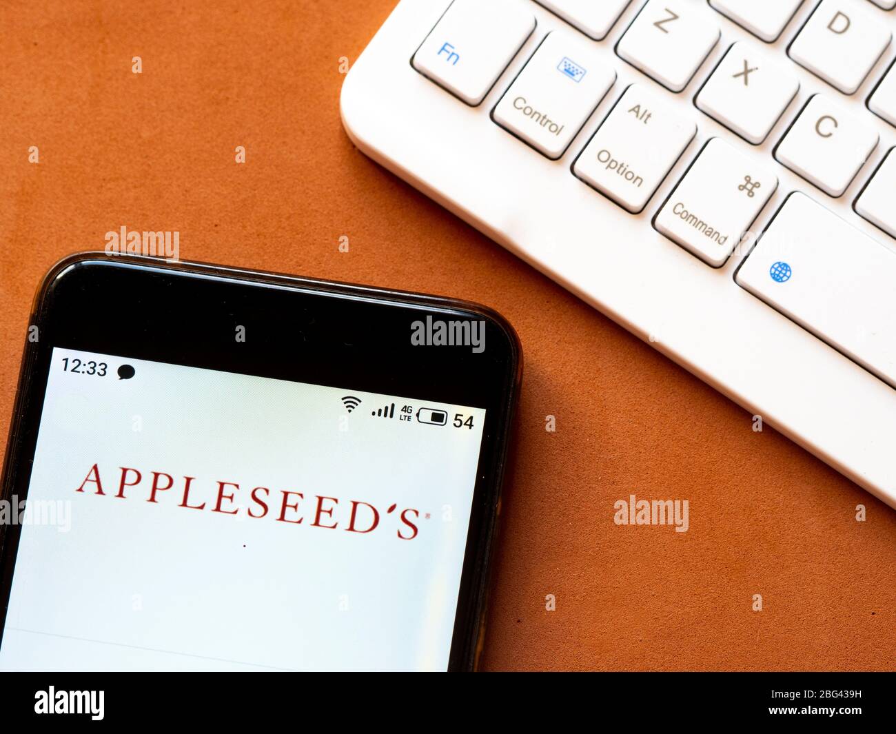 In this photo illustration an Appleseed’s logo seen displayed on a