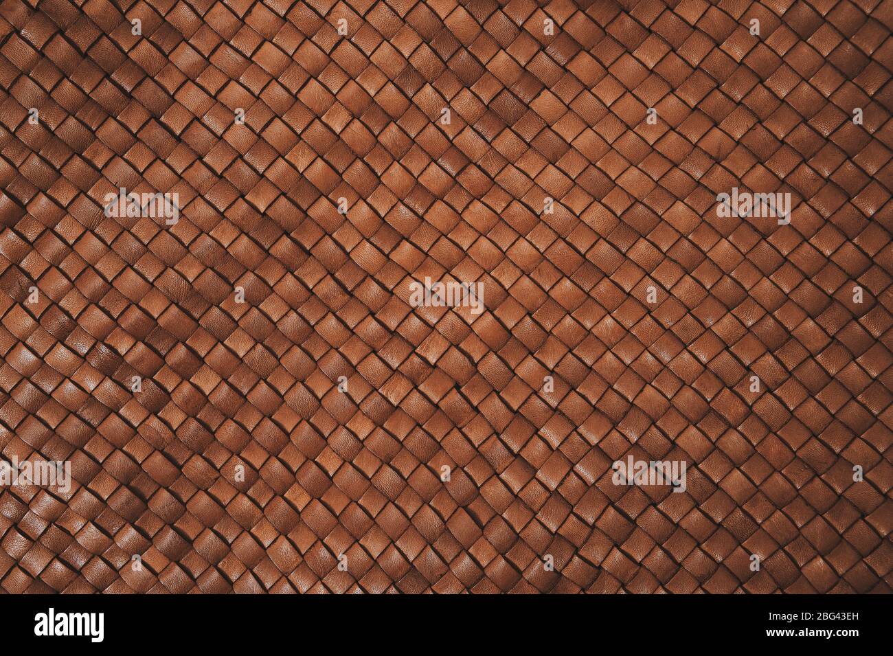 Vintage brown braided leather texture. Leather woven together. Abstract clothing background. Natural material. Horizontal backdrop. Stock Photo