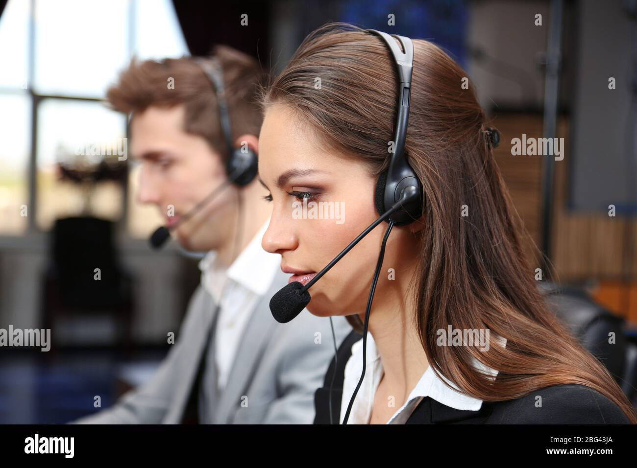 Call center operators at work Stock Photo