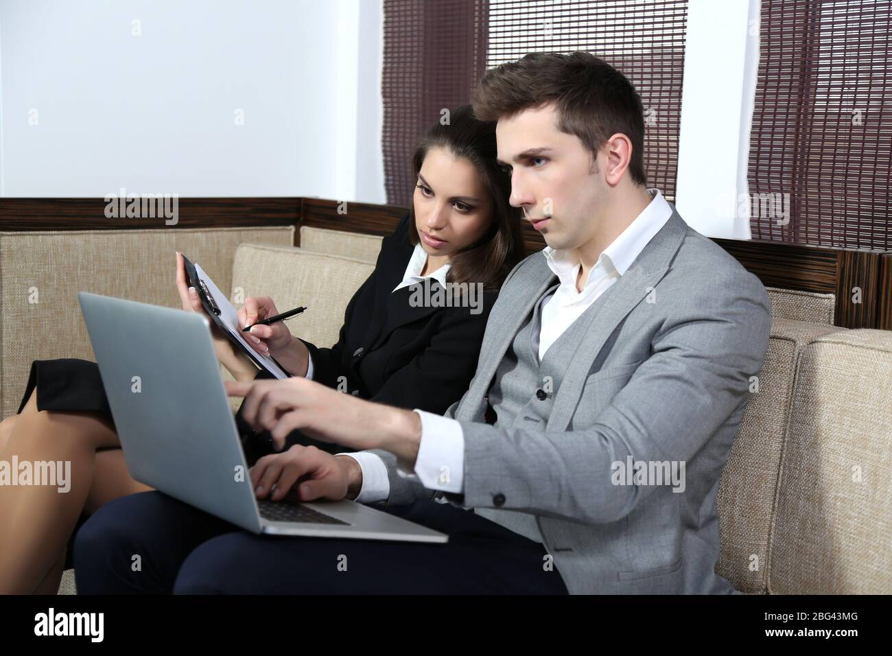 Business people on sofa Stock Photo