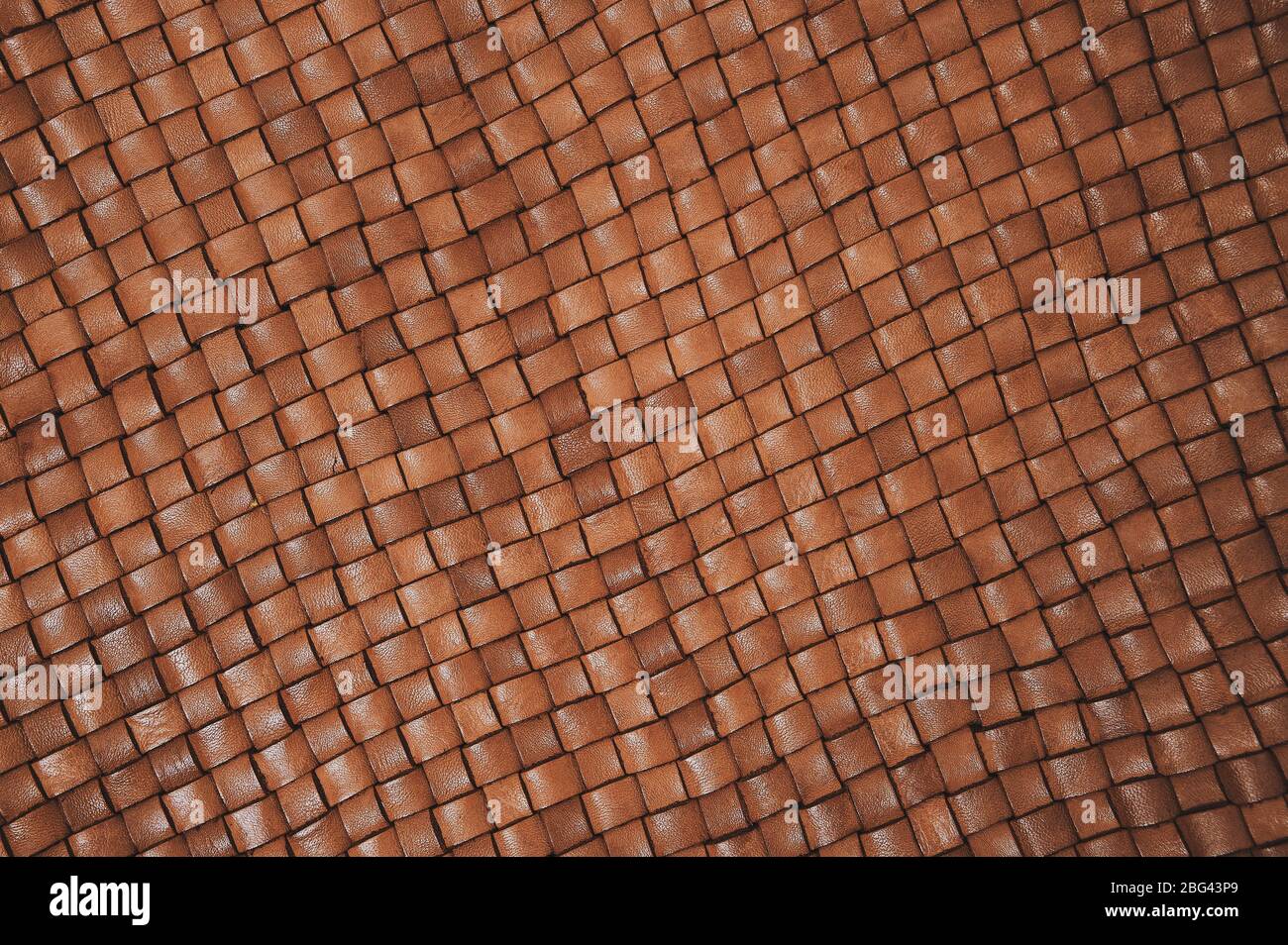 Vintage brown braided leather texture. Leather woven together. Abstract  clothing background. Natural material. Diagonal lines. Stock Photo