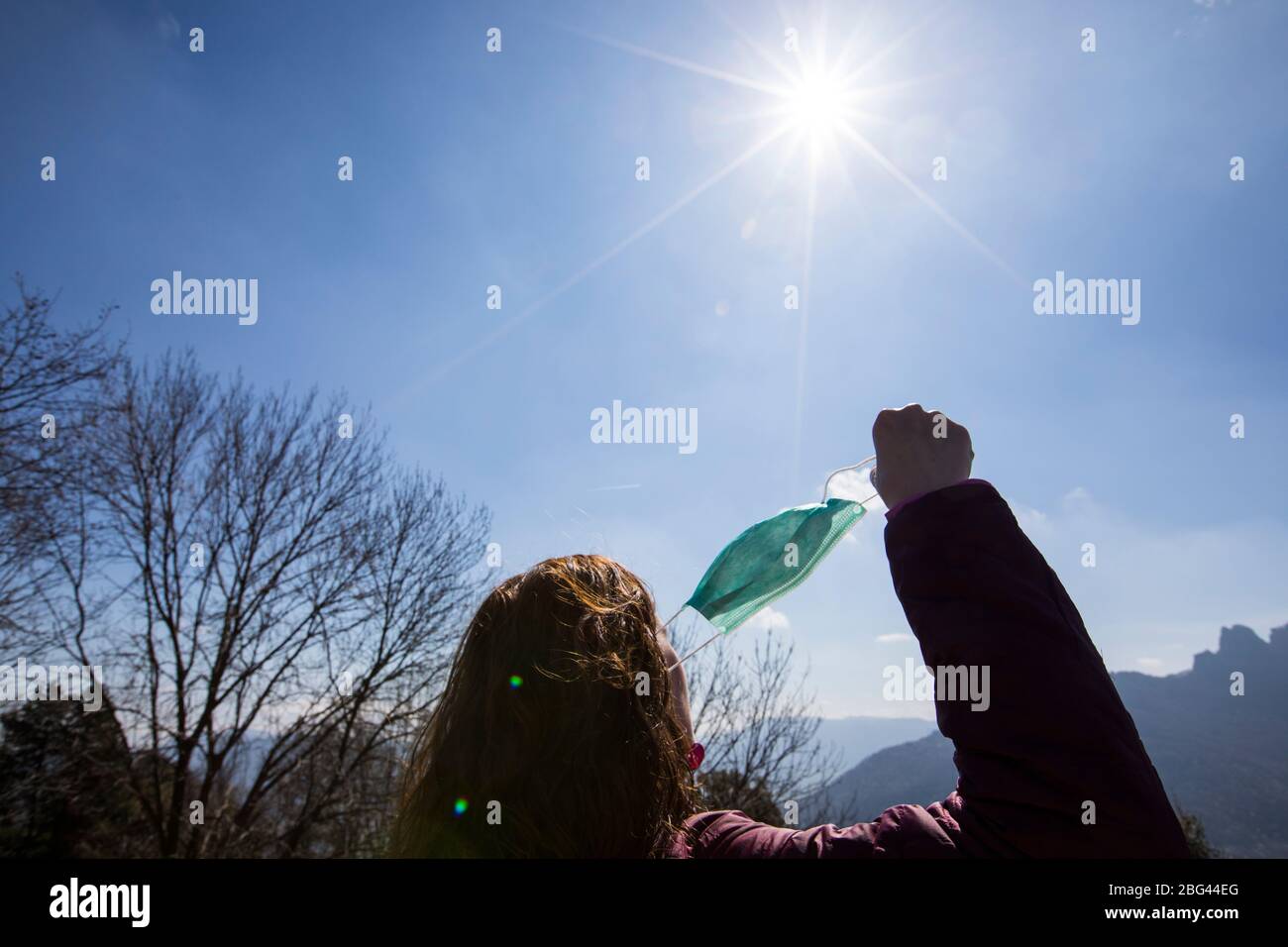 Mid adult woman removing mask hi-res stock photography and images - Alamy