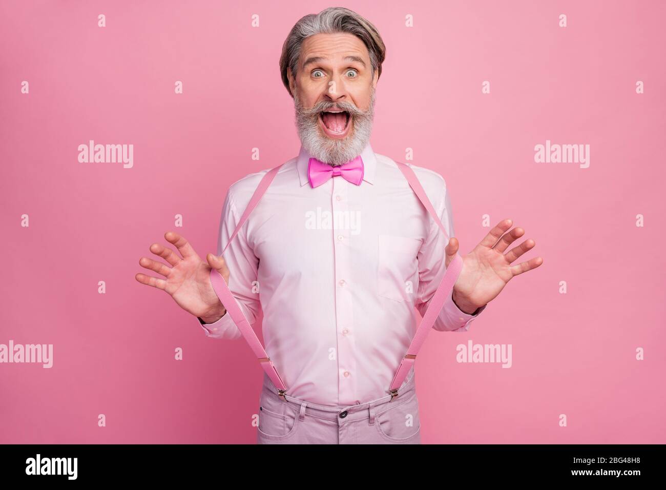 Man wearing white shirt and suspenders hires stock photography and