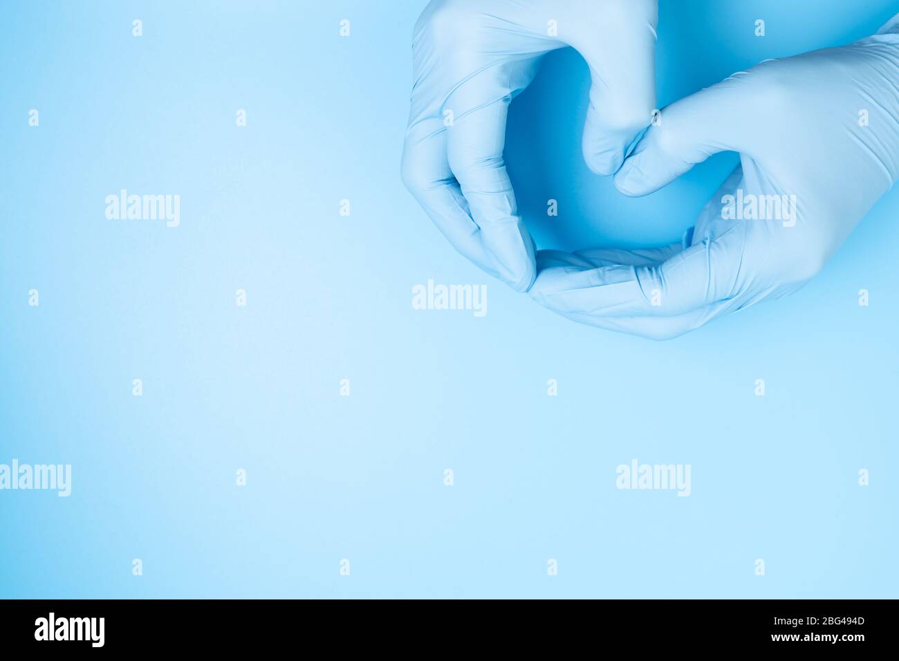 Doctor hands with gloves making heart shape Stock Photo