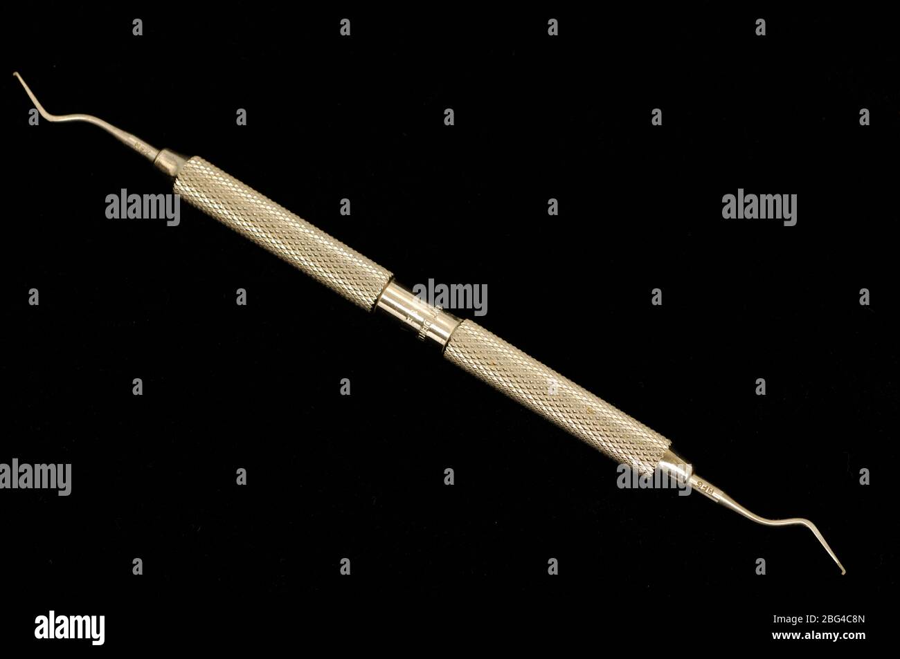 Double ended dental probe used to check a patient's sensitive teeth and gums and to remove plaque. Stock Photo