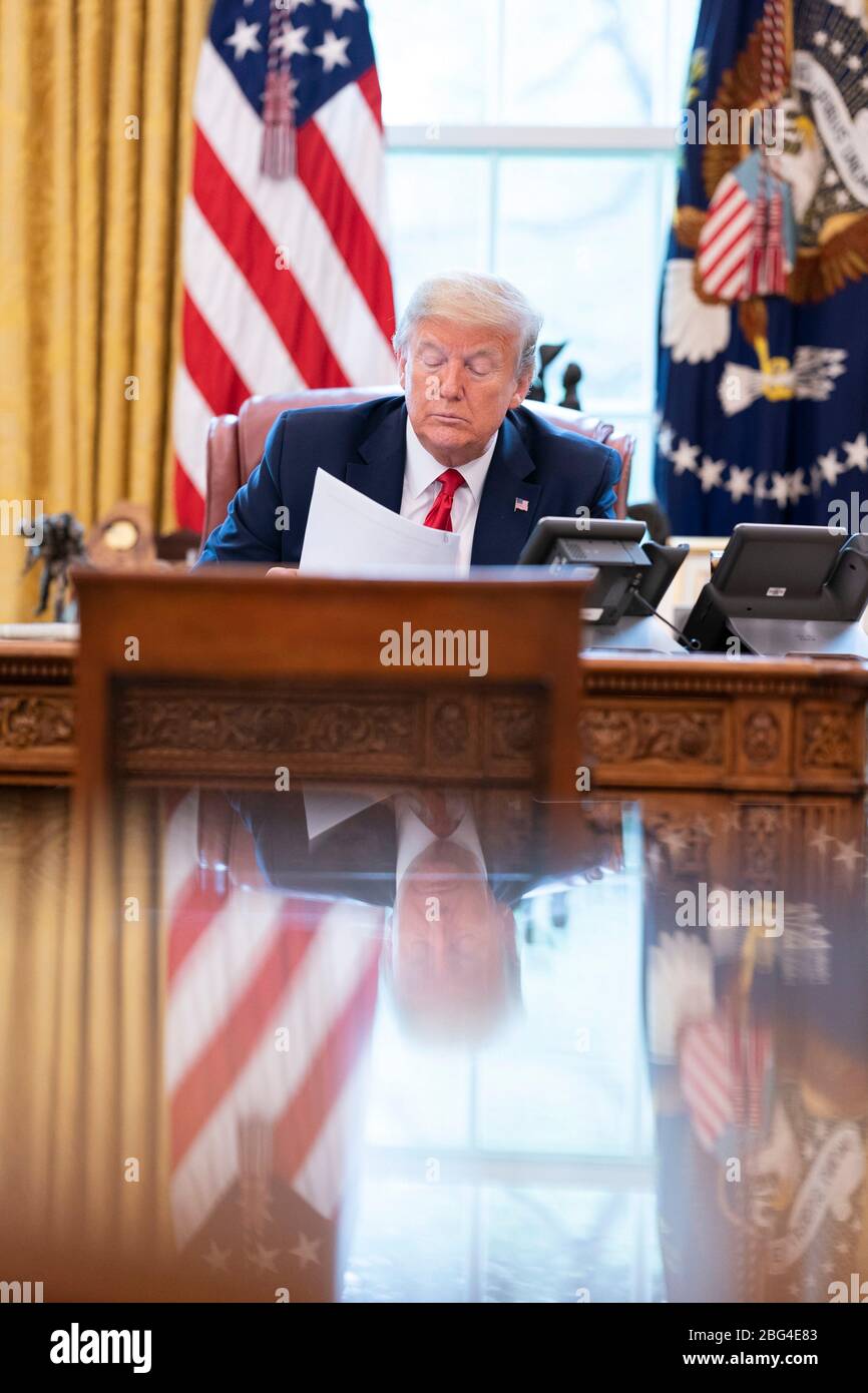 U.S. President Donald Trump talks on the speaker phone with Mexican President Andres Manuel Lopez Obrador in the Oval Office of the White House April 17, 2020 in Washington, DC. Stock Photo